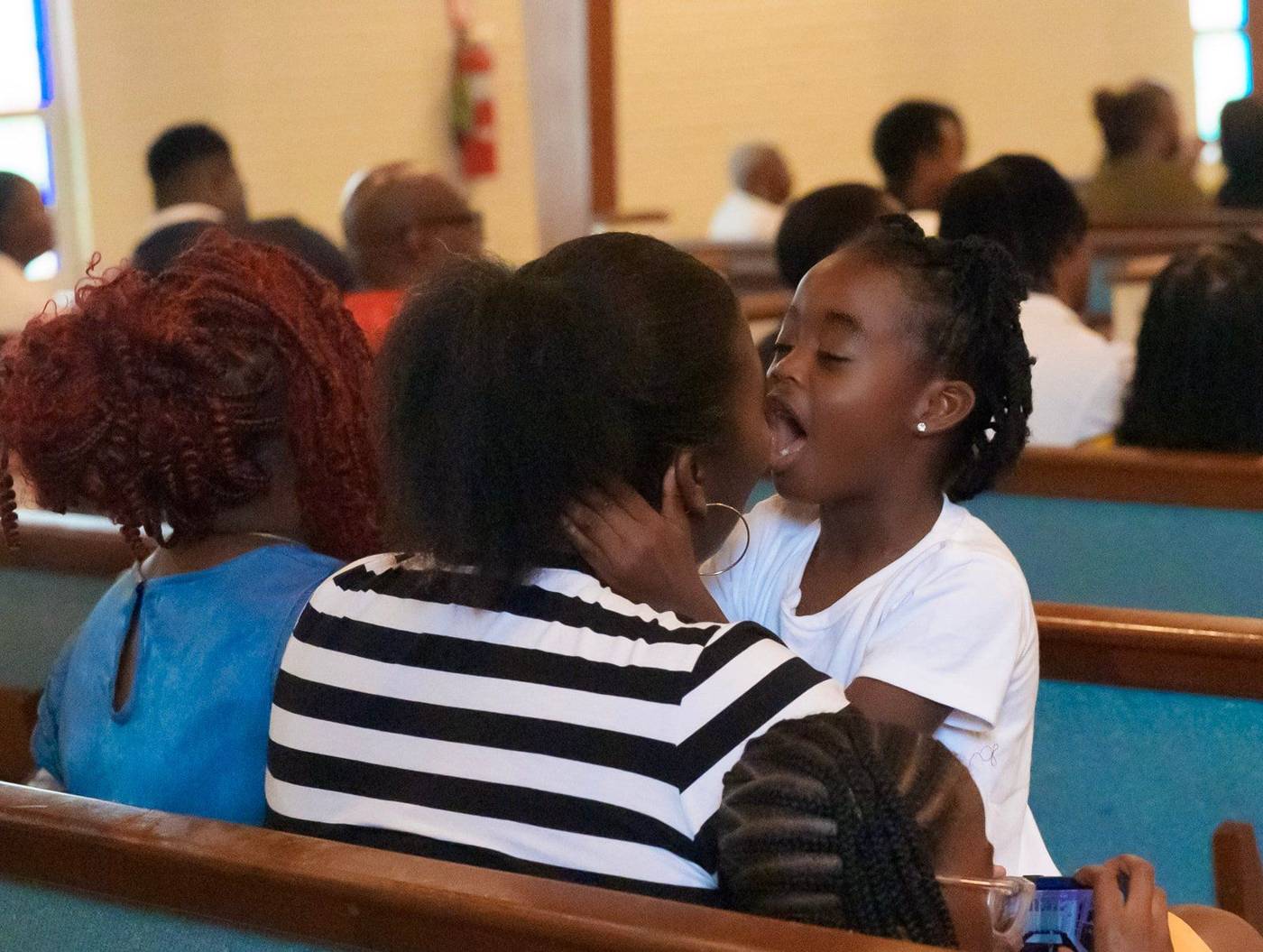 Children sharing a moment in the pews