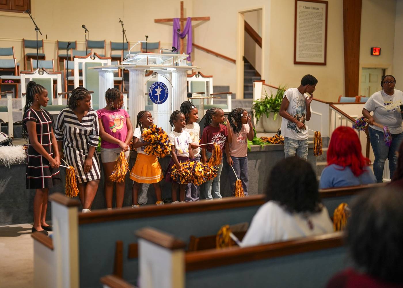 Inside the Shiloh sanctuary: the pulpit, cross and choir loft seen from the pews